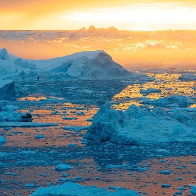 Sun setting over ice floes at Ilulissat Greenland