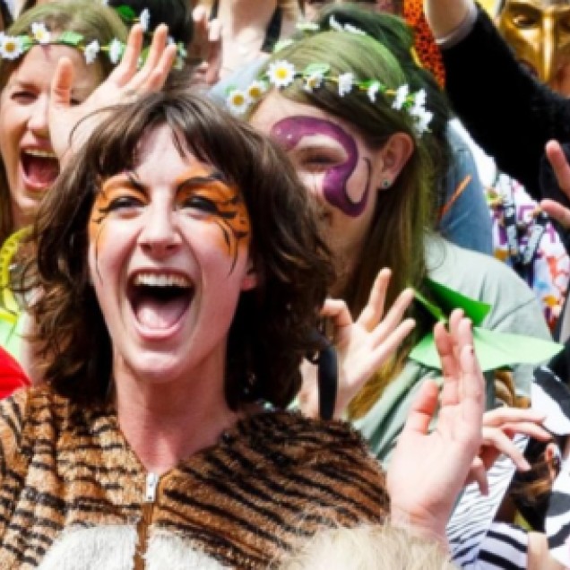 Group of people in wildlife-themed fancy dress cheering at an event