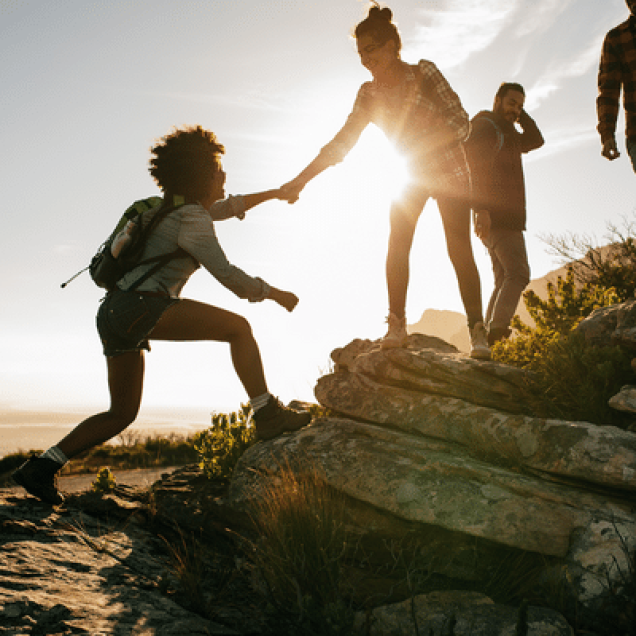 People climbing and helping eachother