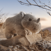 Rhino Toy Standing On Rock