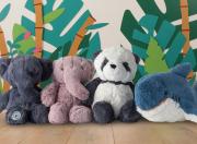 4 soft toys lined up, (2 elephants, panda and shark) against a colourful background.