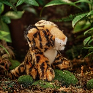 jaguar cuddly toy with a forest backdrop