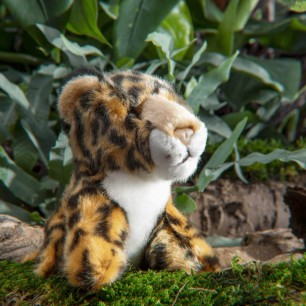 Close up of jaguar cuddly toy with leaves in the background