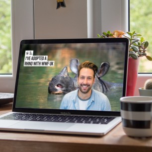 Laptop screen showing man with background image of Rhino in water
