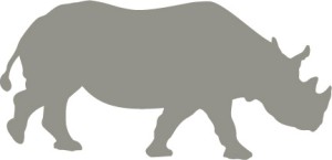 Side profile silhouette graphic of a rhino walking to the right