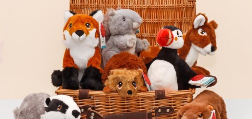 Plush stuffed animals in picnic basket